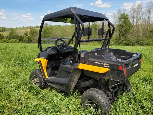 3 Star black soft top on a yellow Cub Cadet Challenger 400, rear three-quarter view in a grassy field