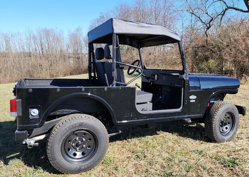 3 Star black soft top installed on the cage of a black Mahindra Roxor, front three-quarter view in a field