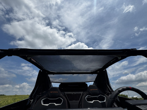 3 Star mesh roof on a CFMOTO ZForce Z10-4 seen from the rear seats, black mesh panel against a cloudy sky
