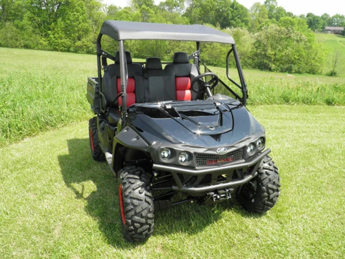 3 Star soft top on a black Intimidator Classic with red seats, front three-quarter view in a sunny field