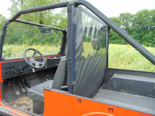 3 Star soft back panel with clear window installed behind the seats of an orange Mahindra Roxor, side view