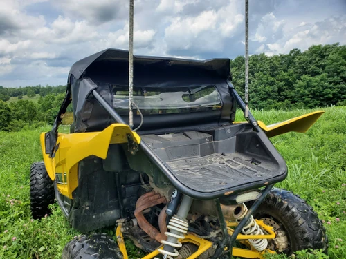 3 Star soft back panel with clear window installed behind the cab of a yellow Yamaha YXZ, rear corner view