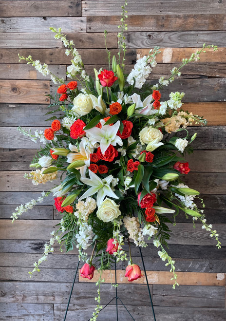 An ode to all Tennessee fans. This standing spray is flush with white and Tennessee orange in lilies, stock, snapdragons, and roses. An ode to all Tennessee fans. This standing spray is flush with white and Tennessee orange in lilies, stock, snapdragons, and roses.
