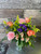 Color Me Yours: a mix of  roses, carnations, wildflowers, and daisies with greenery in a vase.