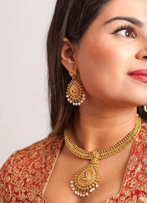 Gold earrings with pink center stone
