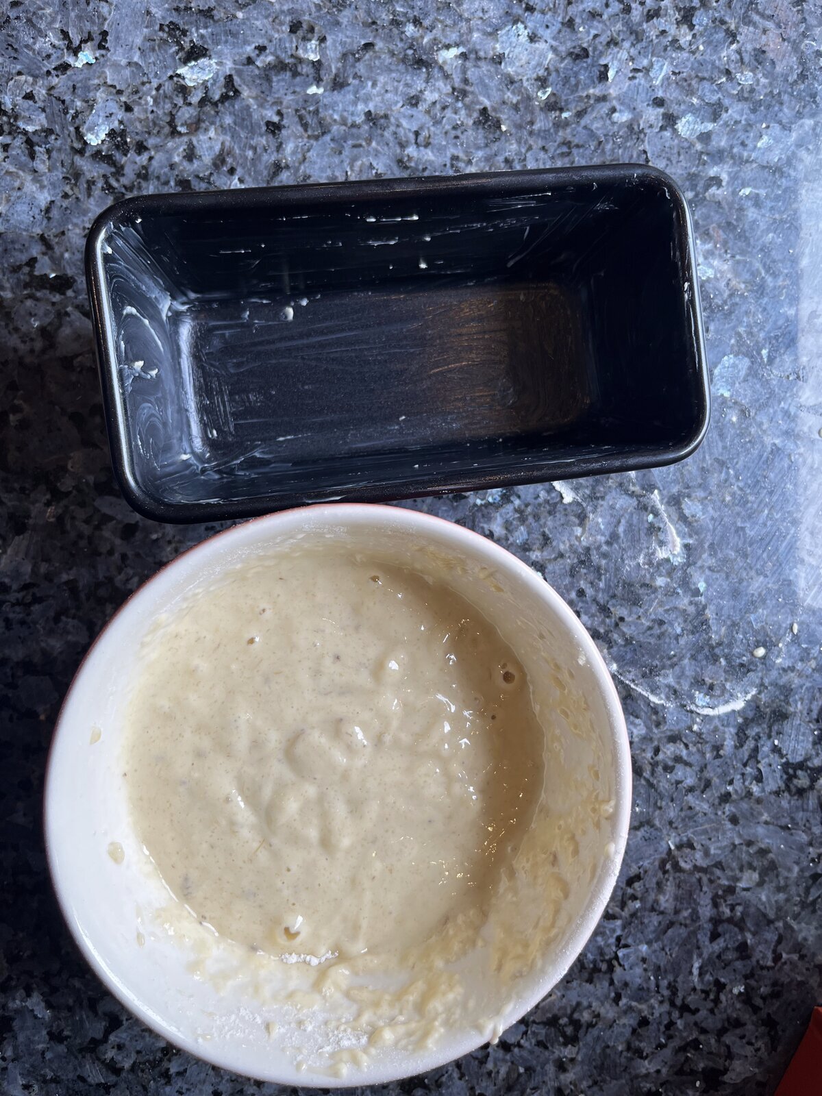 Banana bread batter mixed in a white bowl