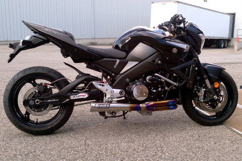 <ul>
<li>Elliptical megaphone with removable race baffle</li>
<li>Show-polished finish</li>
<li>World class craftsmanship, fit, and finish</li>
<li>Dual 18mm O2 sensor bungs pre-installed</li>
<li>Oil cooler removal kit included; oil line kits for oil cooler use available (sold separately)</li>
<li>Fairing modifications required; installation hardware and instructions included</li>
<li>Includes (Emissions/PAIR) Block Off Cap and instructions for decel-pop reduction</li>
<li>May be used with OEM oil pan; aftermarket billet pan suggested for maximum ground clearance</li>
<li>Patented Design</li>
<li>Includes Brock&rsquo;s lifetime direct support package <em>at no additional charge</em></li>
<li><a style="color: blue;" href="%%GLOBAL_ShopPathSSL%%/product_images/uploaded_images/Logo_Plates_Article_Page_Display.jpg" target="_blank">Click here to view logo plate color options</a></li>
</ul>
<div class="moretab" data-title="Product Details">
<p><strong>Titanium Sidewinder Performance Exhaust System</strong></p>
<p>Brock's Performance patented TiWinder&trade; Full Titanium &lsquo;Elliptical&rsquo; Sidewinder for the Suzuki B-King. World-class engineering and craftsmanship are combined with exotic materials to produce an exhaust system second to none.</p>
<p>Developed for use in conjunction with 1&rdquo; deep aftermarket oil pans, utilizing our &lsquo;elliptical&rsquo; megaphone outlet for maximum ground clearance during the hardest chassis-dragging launches. This additional ground clearance also makes our patented TiWinder&trade; more user-friendly during cornering as a result of the best right hand clearance on the market. Note: Stock oil pan may also be used.</p>
<p>Utilizing our industry-first 4-2-1 Sidewinder configuration, the patented TiWinder&trade; outperforms any other system we have ever tested/manufactured not only on the dyno, but, more importantly, during real world drag strip testing. Stock displacement to BIG CC &lsquo;mountain&rsquo; motors benefit alike from maximum peak AND average horsepower combined with a smooth linear torque curve throughout the entire rev range from launch to limiter. Constructed of a combination of pure and exotic titanium alloy tubing, we offer the first aftermarket production motorcycle exhaust system in the world to use high-temperature titanium alloys in critical areas to handle the extreme temperatures generated by the use of nitrous oxide. The &lsquo;grudge&rsquo; crowd will be happy to hear that the entire system only weighs 5.3 lbs. without the baffle.</p>
<p>Spring-mounted utilizing our &lsquo;big cc&rsquo; stainless steel spigots with billet aluminum clamp plates for quick, between round maintenance and designed for use with stock or quick access clutch covers (modification to certain aftermarket covers required - consult our technical department for additional details).</p>
<p>Dual O2 bosses allow independent air/fuel measurements in head pipes 1&amp;2 and/or 3&amp;4 for more precise cylinder &lsquo;trim&rsquo; measurements.</p>
<p>System includes replacement laser-cut stainless steel lower radiator mounting bracket, and a longer rear brake clevis to allow use of your stock rear brake lever. Right side fairing modifications required; instructions included. Ask anyone who has picked up one of these works of art&hellip; &rdquo;WOW!&rdquo; and &ldquo;DAMN!&rdquo; are the most used terms.</p>
</div>