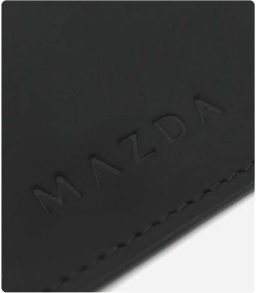Made with the same top-grain leather found in Mazda vehicles and bound together with fine hand stitching.