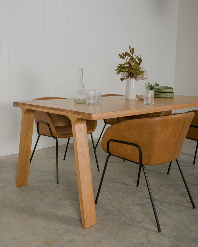 Contemporary dining room featuring butterscotch Henry dining chairs and the Harrison oak dining table