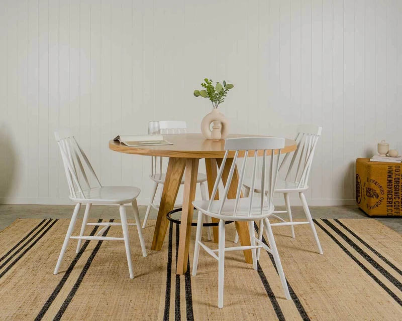 White Odette dining chair paired with an oak round table