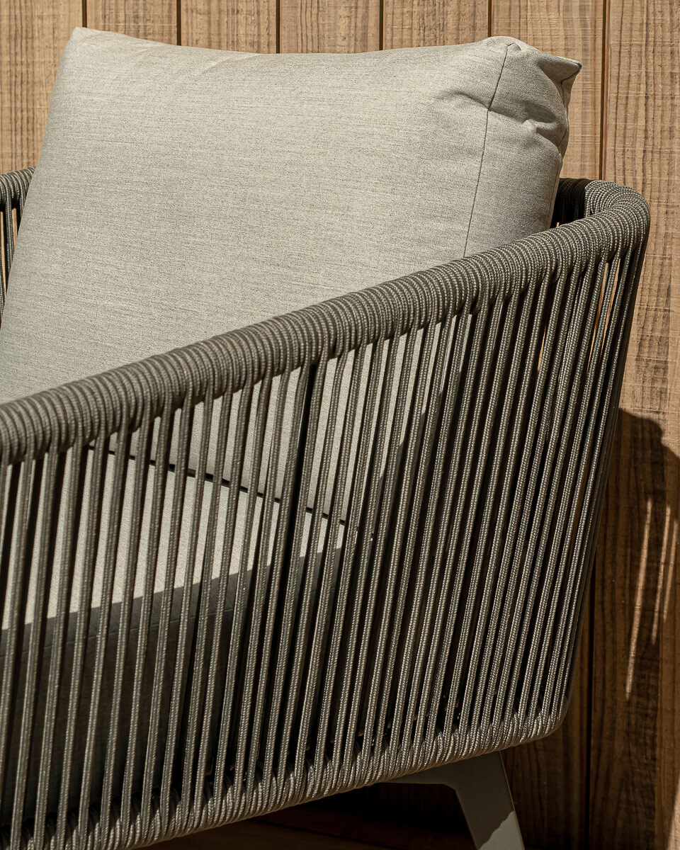 Charcoal strung outdoor rope on the armrest of an outdoor lounge chair