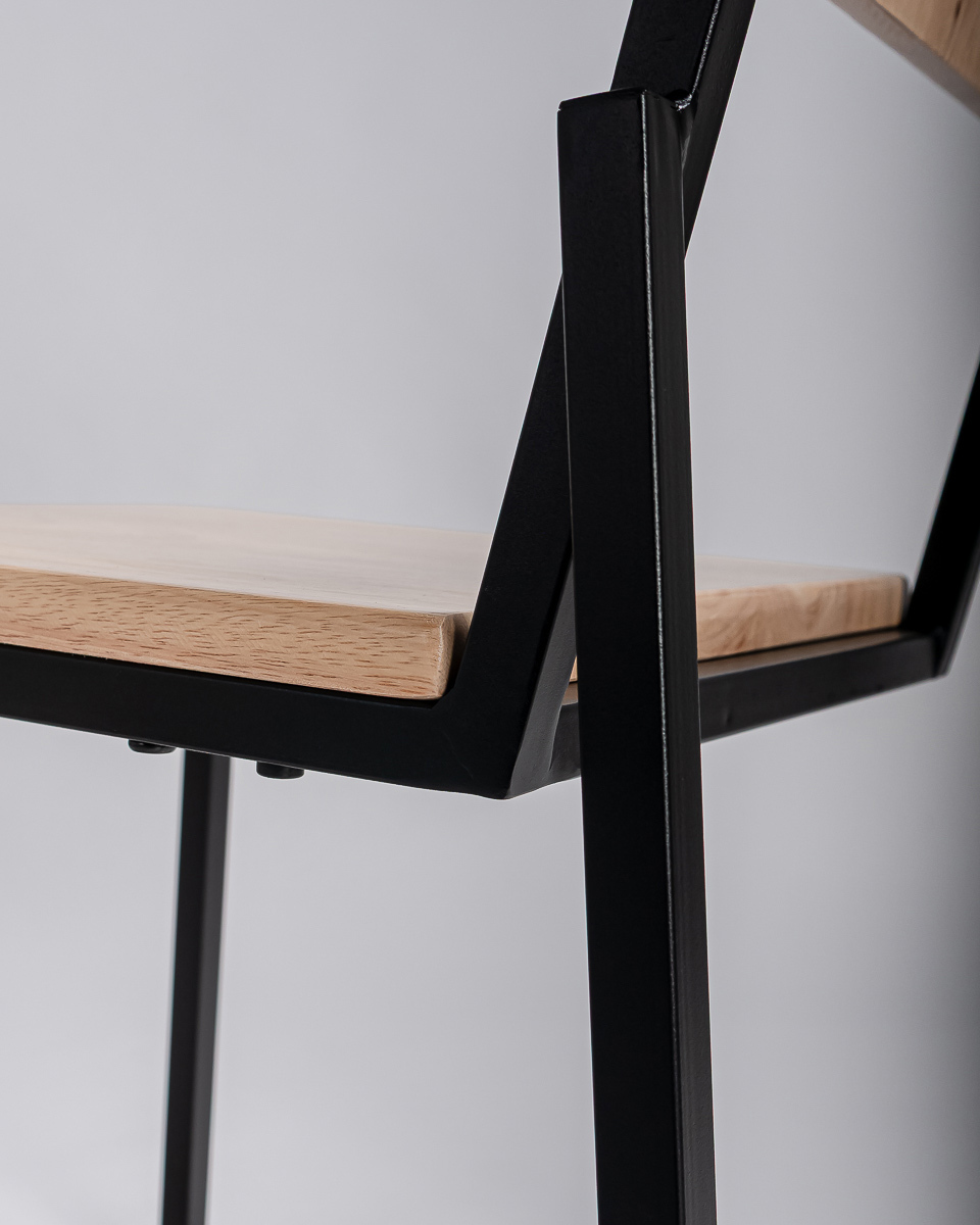 Close up of a chair with black frame and edgy details