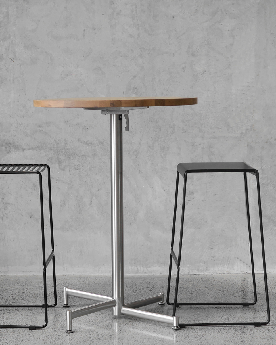 Stainless steel base and table top with two black stool.