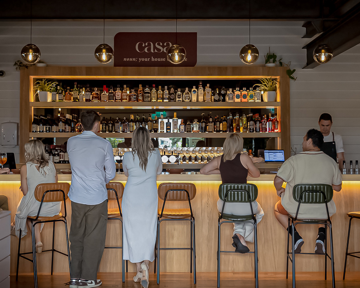 Industrial-style Barry bar stools styled at the bar of a modern restaurant in Napier, featuring upholstered seating, black metal frames, and warm hospitality interiors.