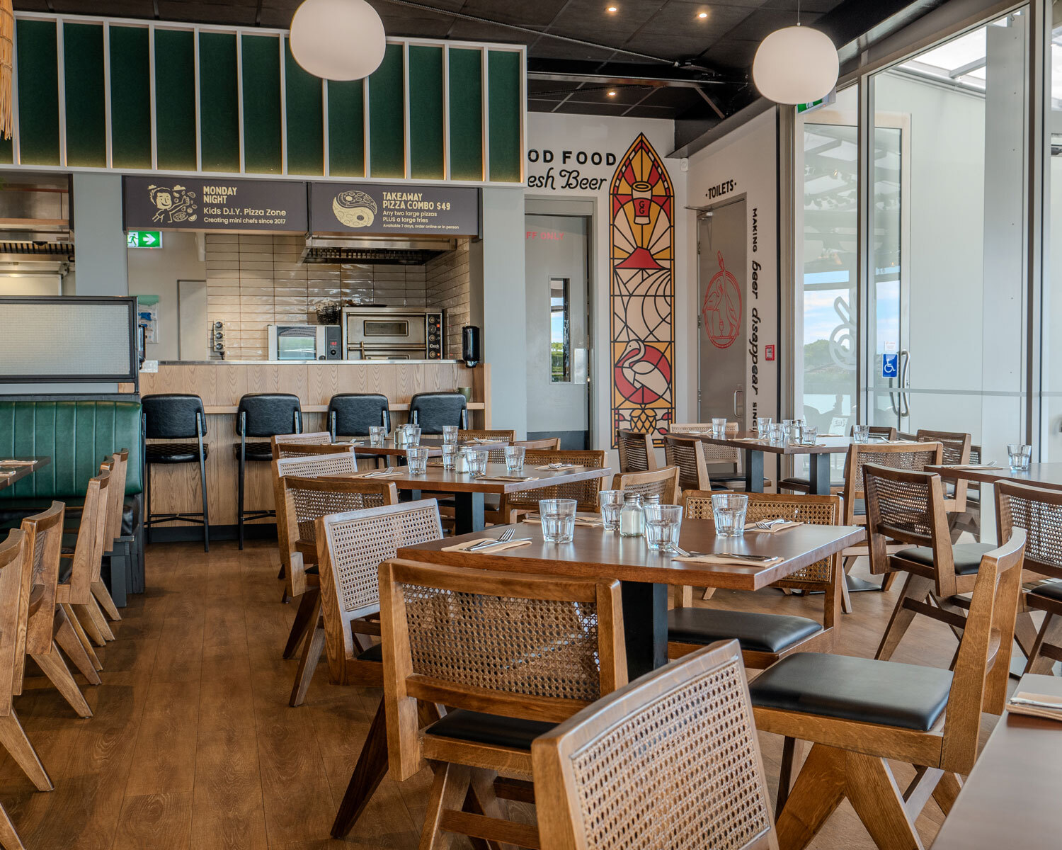 Good Local's restaurant with dark oka timber seating and tables with green coastal hues.