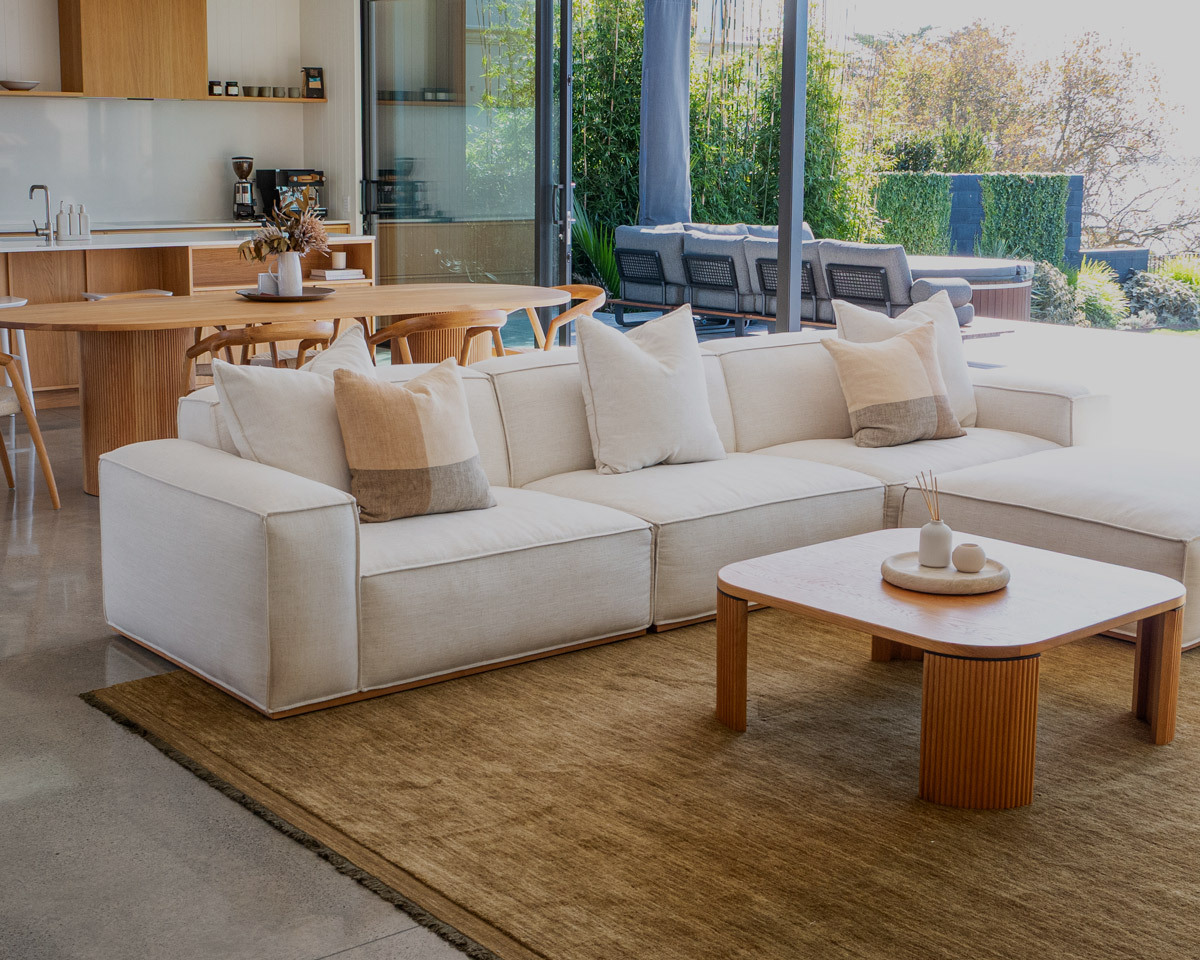Contemporary living room featuring the Hayes modular fabric sofa, Reid coffee table, and Weave wool rug in Oakmoss.