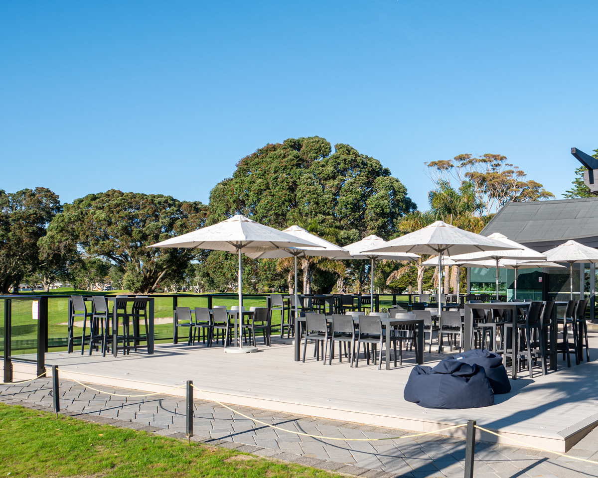 Renovated outdoor clubhouse deck at Mount Golf Club with weather-resistant dining furniture overlooking the golf course.