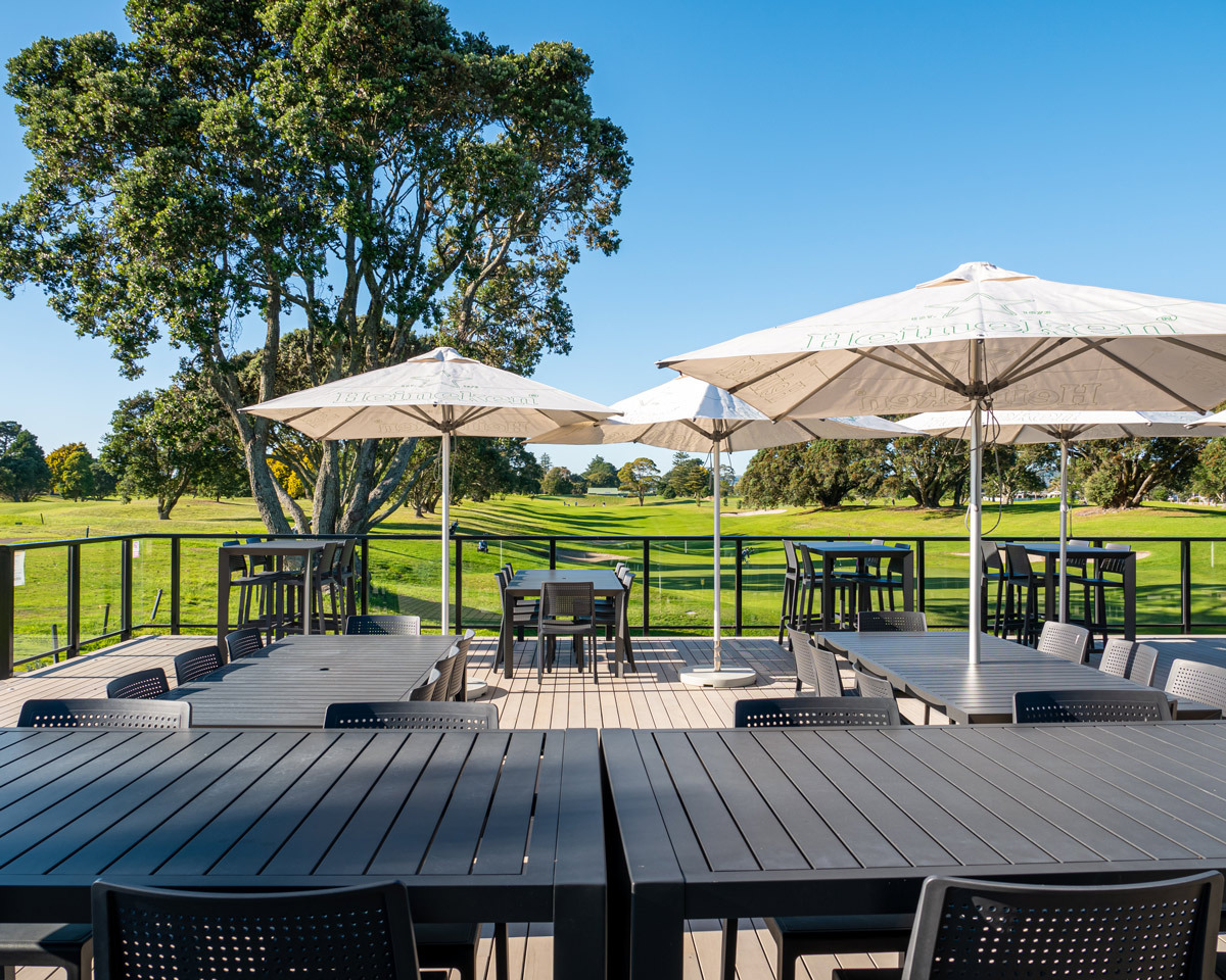 Modern outdoor furniture in anthracite complementing the clubhouse exterior and light-coloured decking.