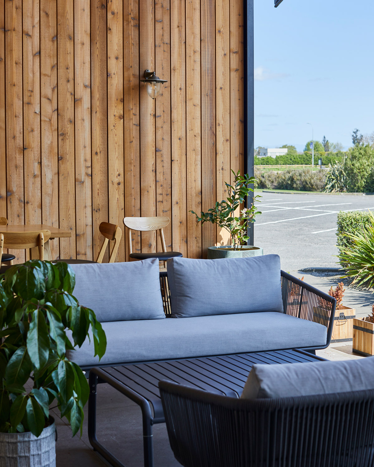 Outdoor lounge area at Off The Track Restaurant featuring modern rope outdoor seating and coffee tables in a covered hospitality setting.
