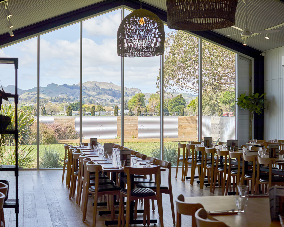 Large hospitality dining space furnished with timber restaurant tables and chairs at Off The Track Restaurant.