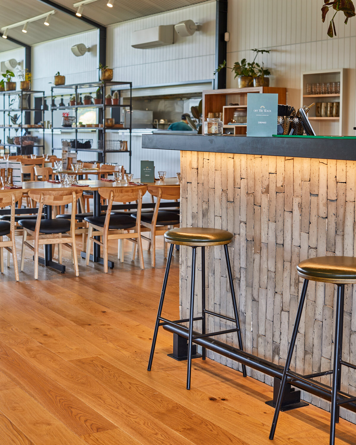 Bar area at Off The Track Restaurant featuring commercial bar stools, timber flooring and hospitality furniture.