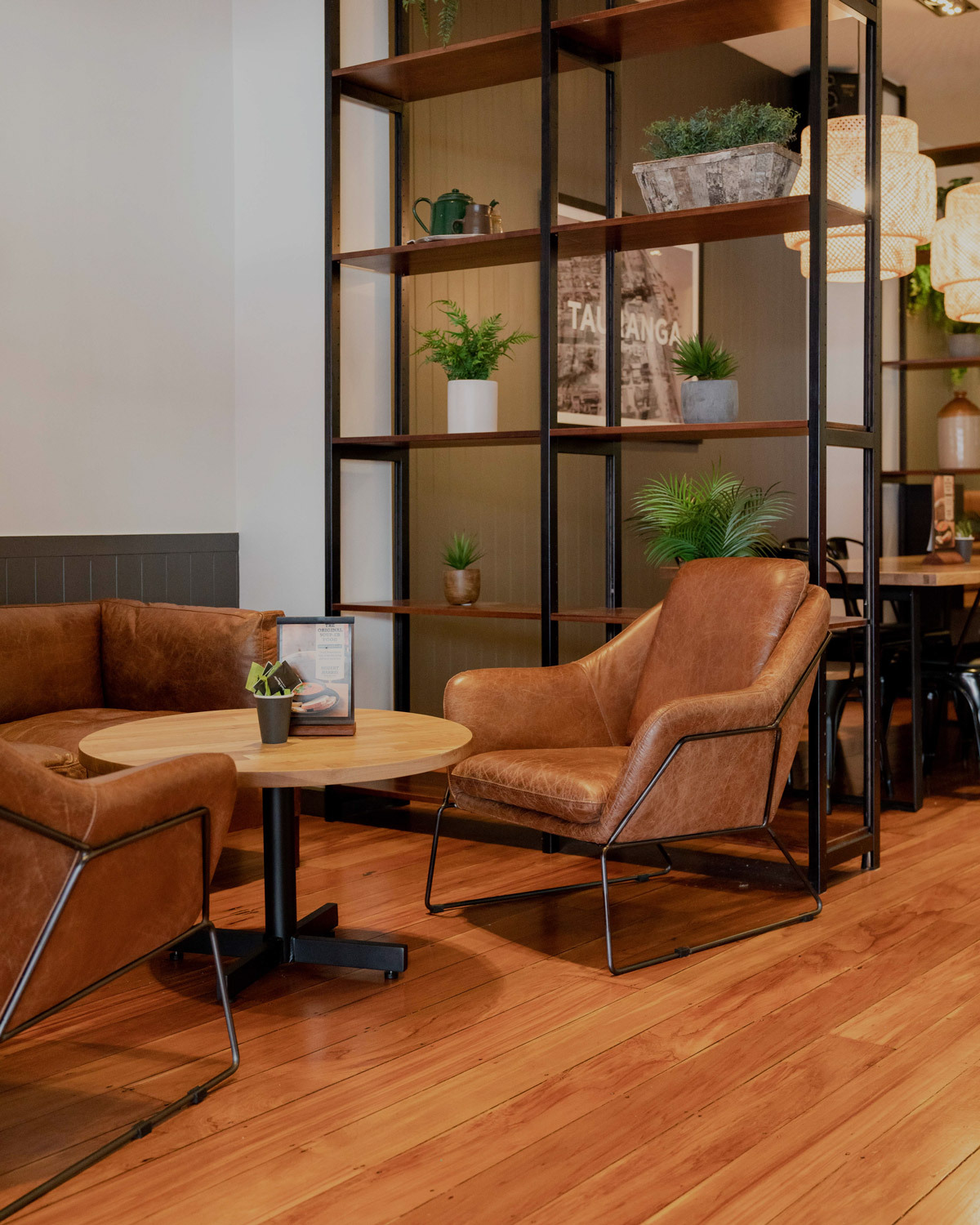 Tan leather Harold Armchair in a Robert Harris Cafe.