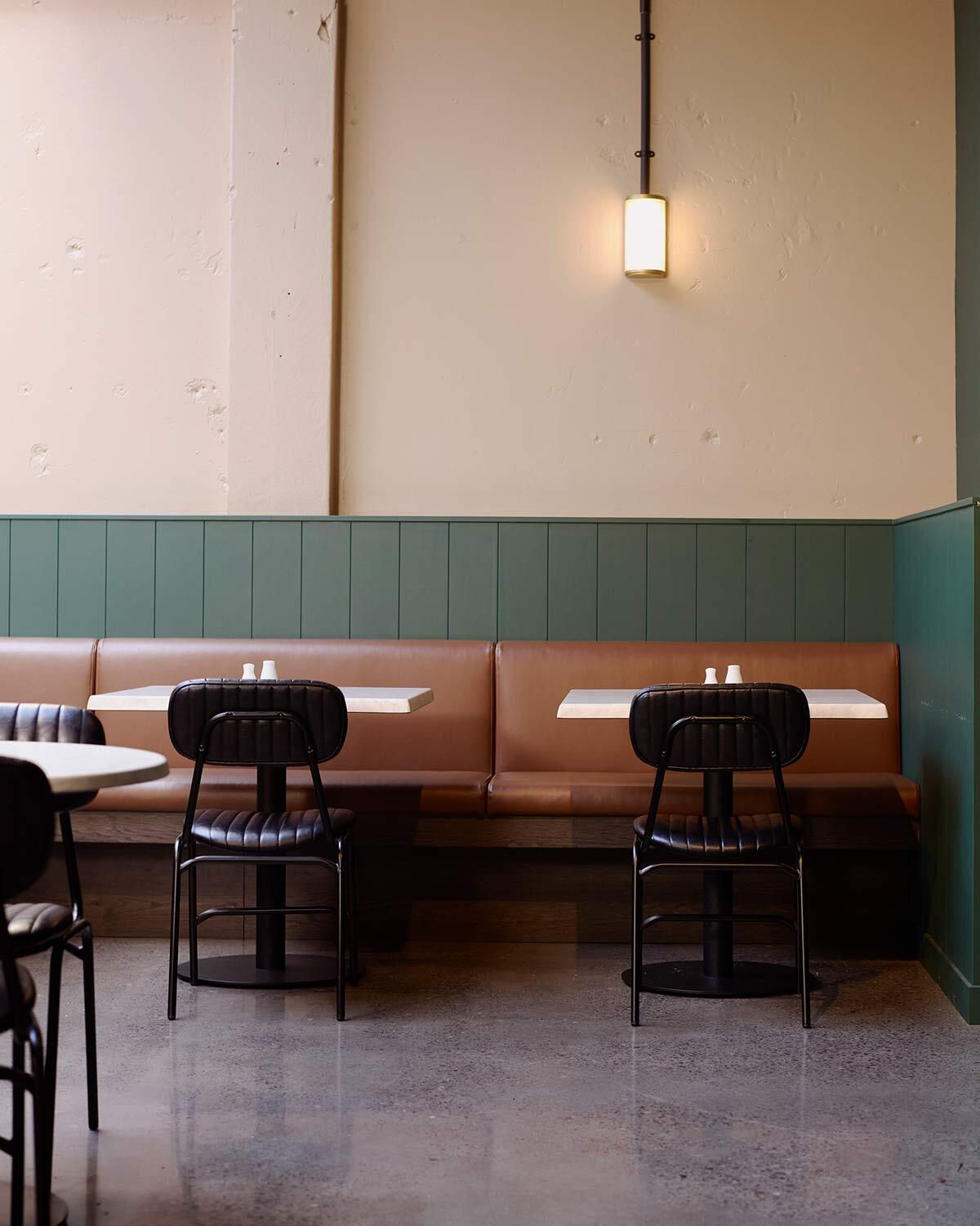 Barry chairs paired with Toulouse table tops and Hydra bases beneath the skylight at The 19th