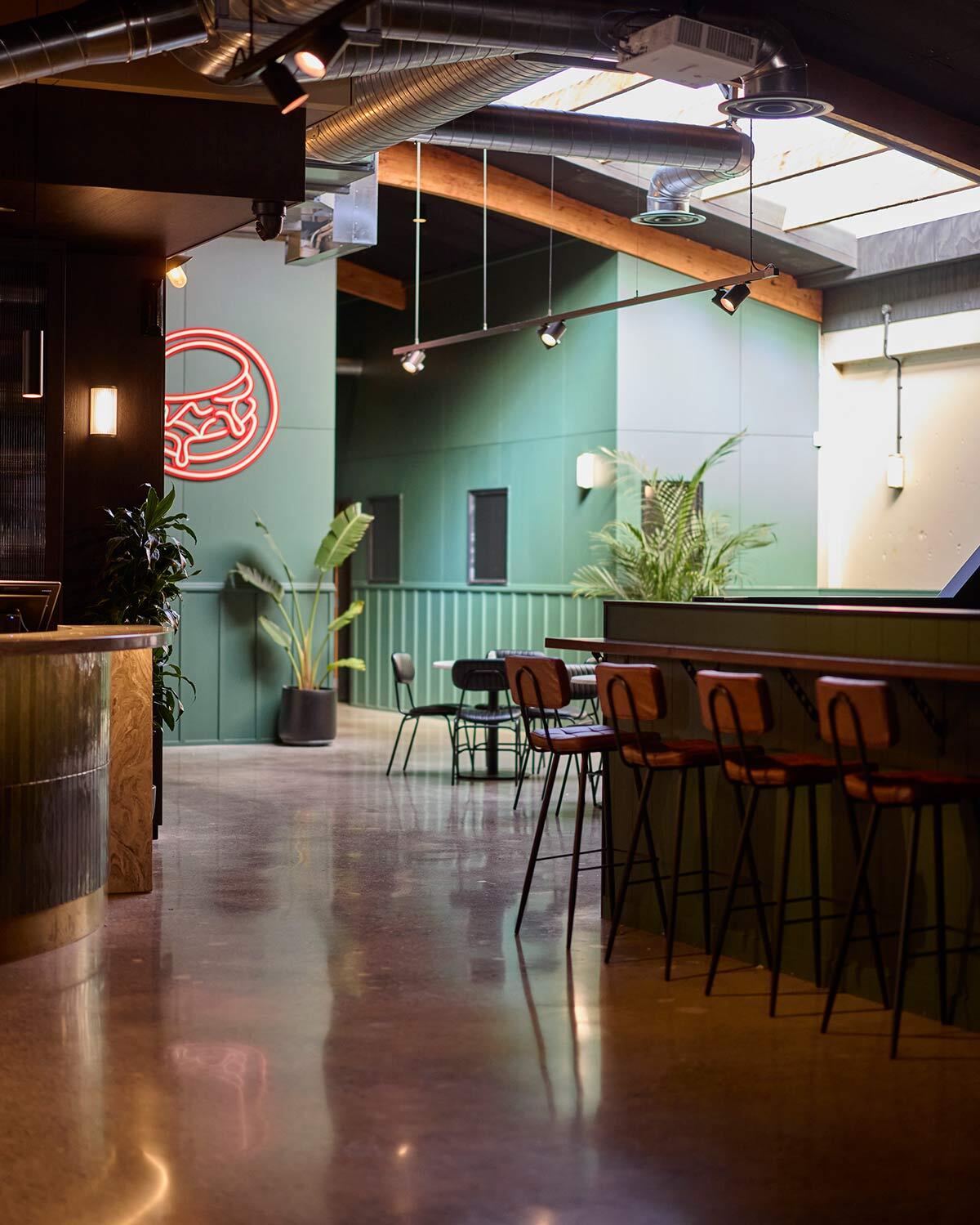 Walter bar stools in Chestnut alongside Barry dining chairs in The 19th hospitality space