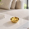Feng Shui Metal Money Bowl displayed on a modern living room table