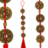 five emperor coins hung on a wall with red string