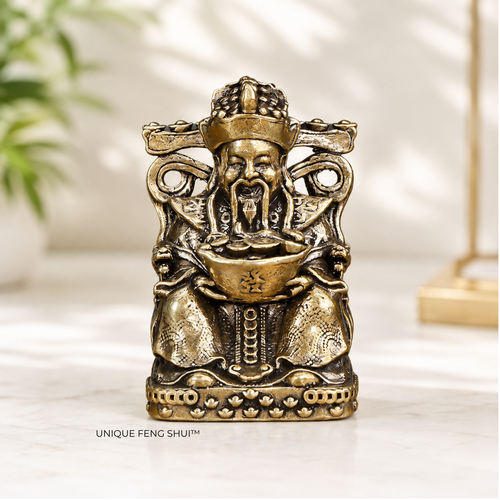God of Wealth figurine in bronze, displayed on work desk 