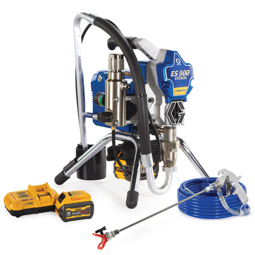 A Graco ES 500 battery-powered airless stencil rig featuring a blue and silver motor housing mounted on a black metal stand. The unit is shown with two DEWALT FlexVolt batteries, a yellow fast charger, a coiled blue airless hose, and a silver spray gun with a long extension wand and red tip guard.