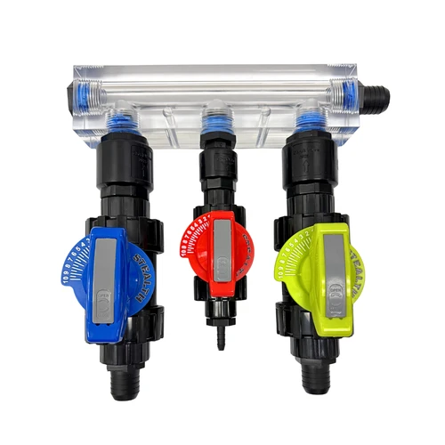 Direct front view of the Stealth 1-inch soft wash proportioner for 8+ GPM systems, showcasing the clear block manifold, dual 1-inch water and bleach metering valves with blue and yellow handles, and a 1/2-inch soap valve with red handle and a 1/4" barb.