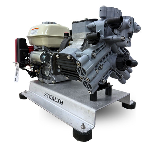 Three-quarter front view of the Stealth Soft Flow Series P40 soft wash skid, showing the gray Comet P40 diaphragm pump head, the black gearbox enclosure, and the side profile of the Honda GX200 engine