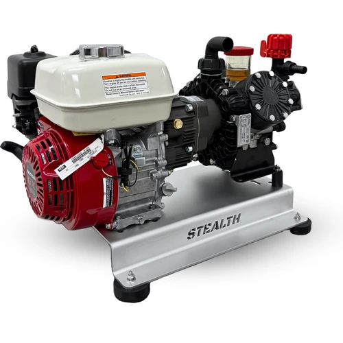 Three-quarter pump-side view of the Stealth AR45-SW soft wash system, showing the red pressure regulator, oil sight glass, black gear drive, Honda GX200 engine, and aluminum skid frame