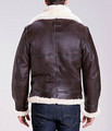 Back view of sheepskin shearling jacket on model with full, cream fur-lining and collar,  dark cross-stitching on the back