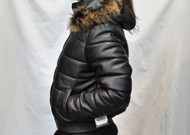 Sideway view of leather jacket on model with light puffer design and real fur hood. 