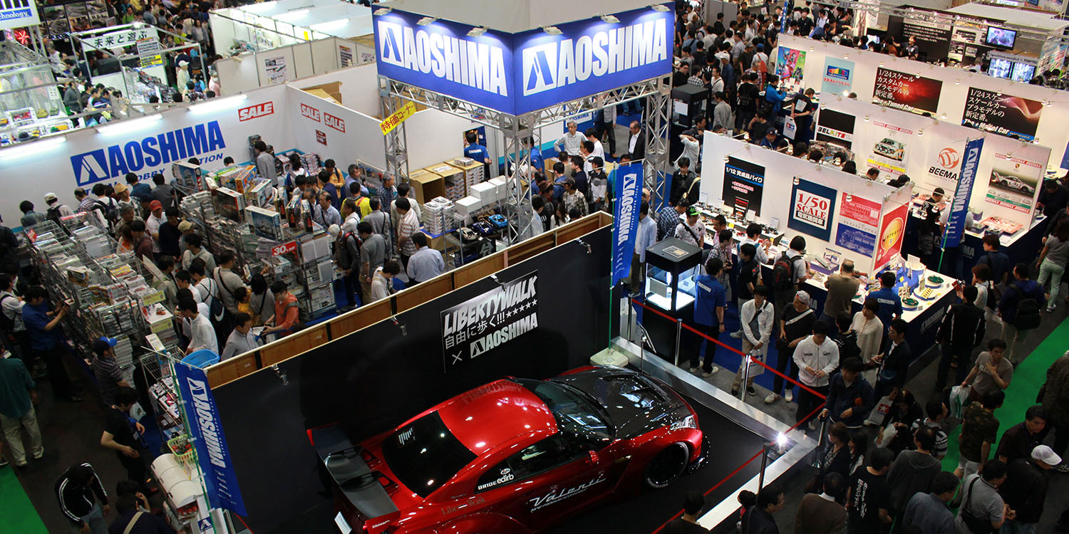 Busy Aoshima display stands at a show.