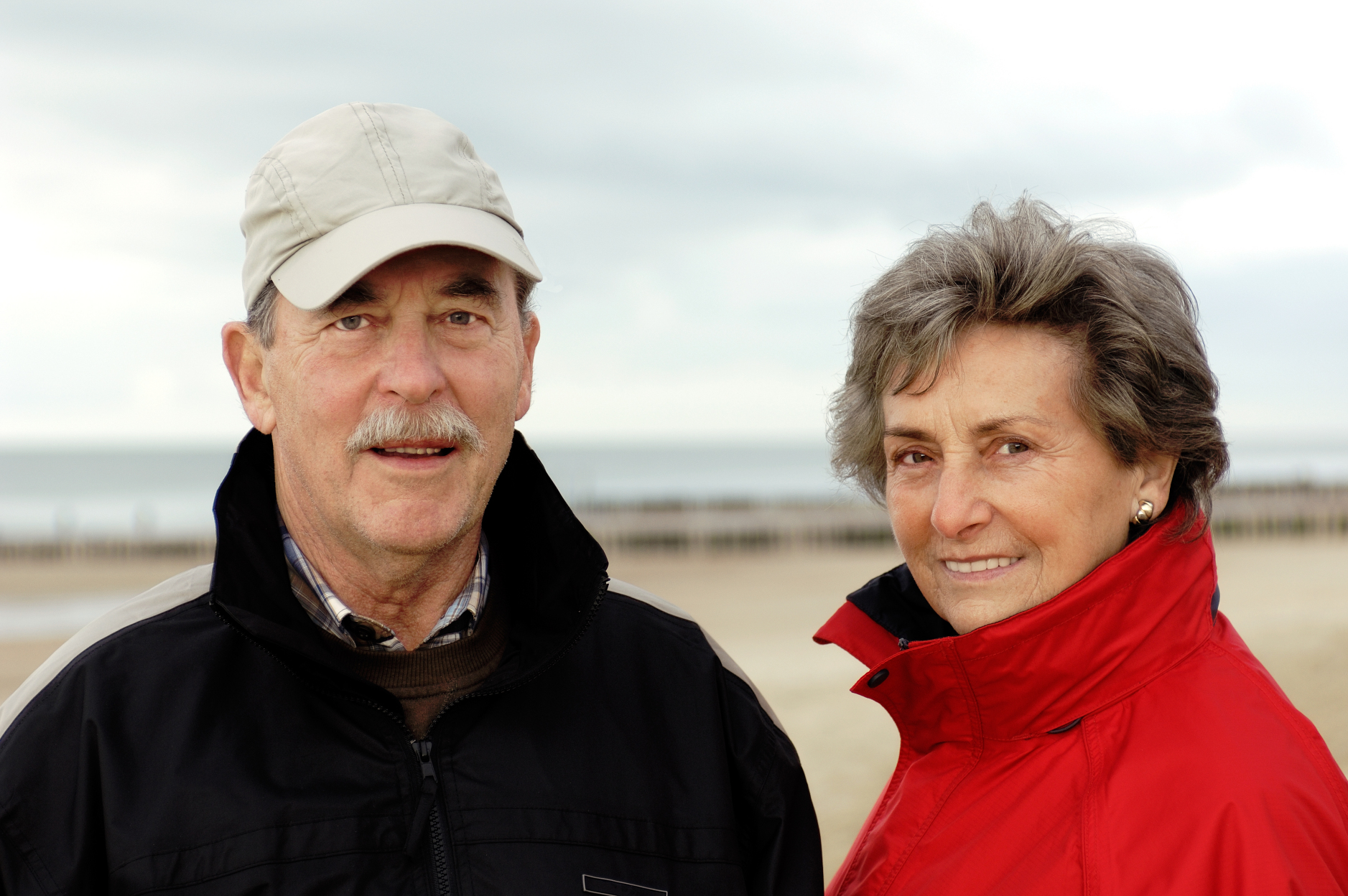 Active seniors walking on the beach at low tide.