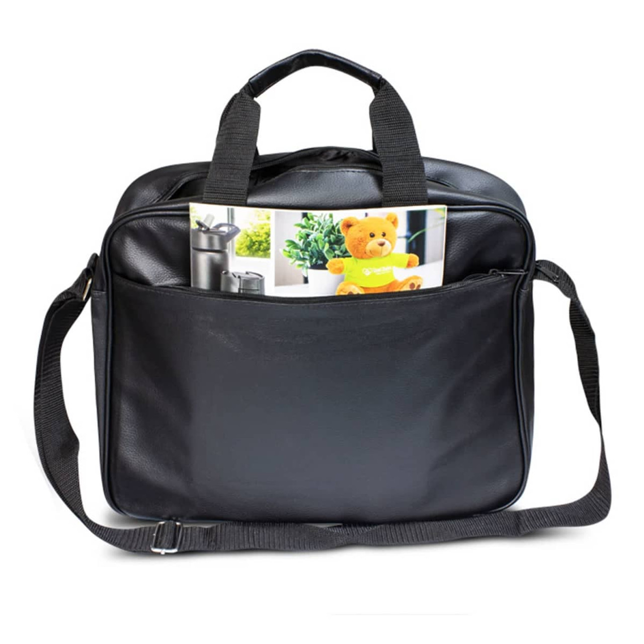 A black laptop bag featuring double handles and a shoulder strap, with a magazine and a teddy bear visible in the front pocket.