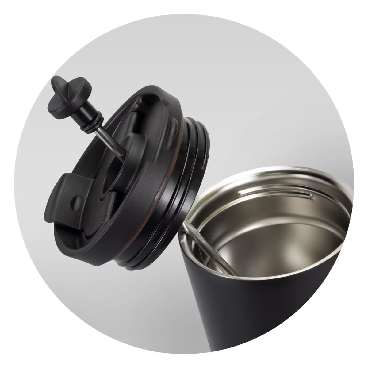 A drink bottle with a black exterior and a lid featuring a plunger mechanism, revealing a stainless steel interior.