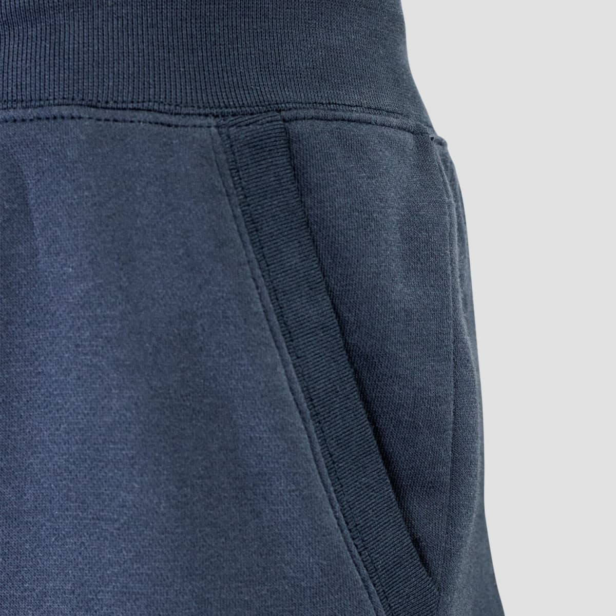 Dark navy unisex sweatpants featuring a side pocket and elastic waistband, with a subtle logo detail.