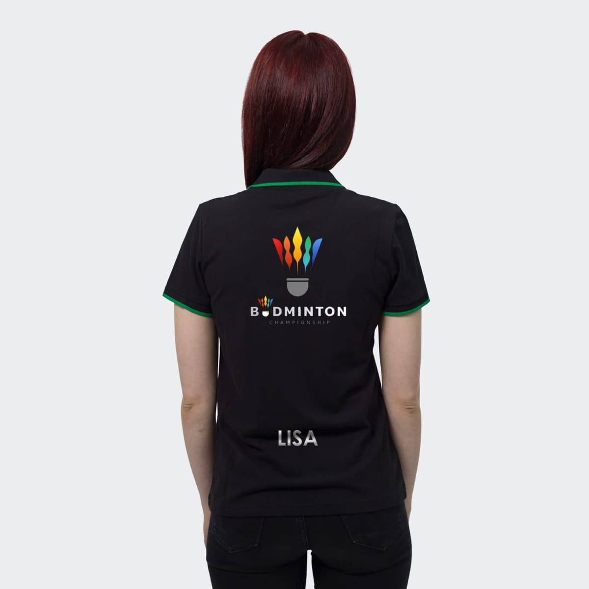 A black women's polo shirt with green accents, featuring a logo on the back and a name on the lower hem.