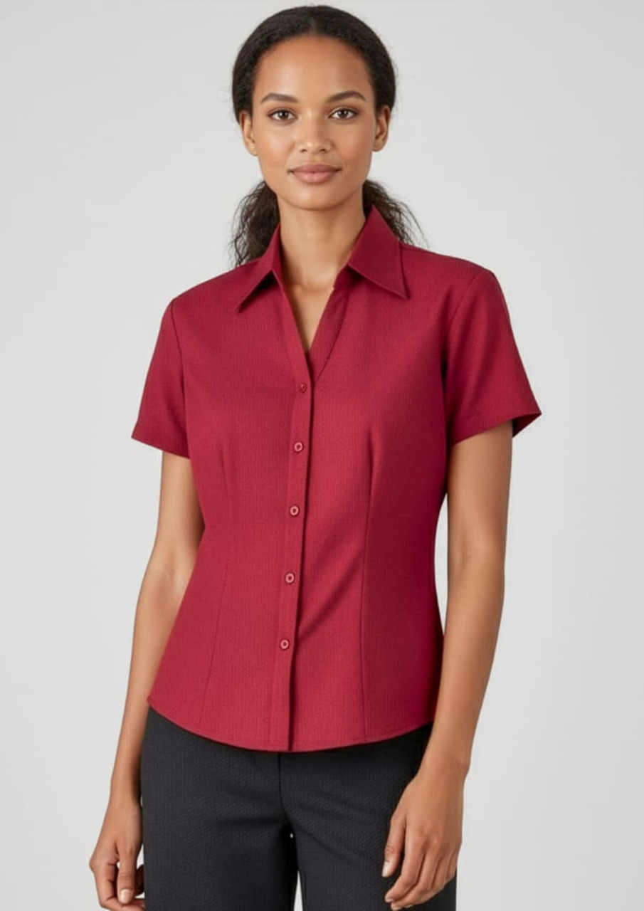 A red short sleeve button-up shirt with a fitted design and a collar. The shirt features buttons down the front.