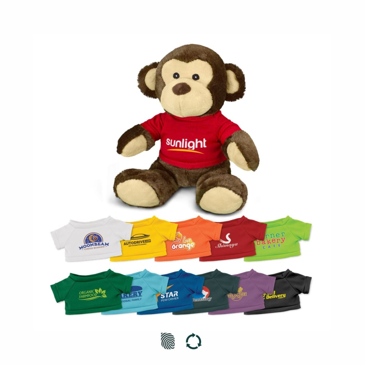 A plush monkey toy in brown and beige, wearing a red shirt with a logo and surrounded by various colourful t-shirts.