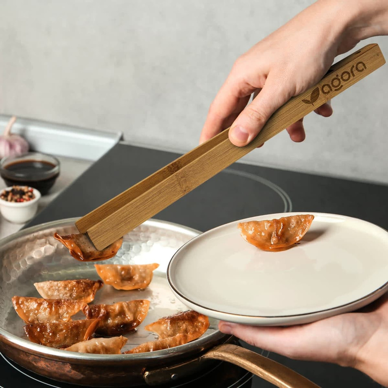 Bamboo serving tongs in a rectangular kraft paper box with a logo, featuring a natural wood finish.