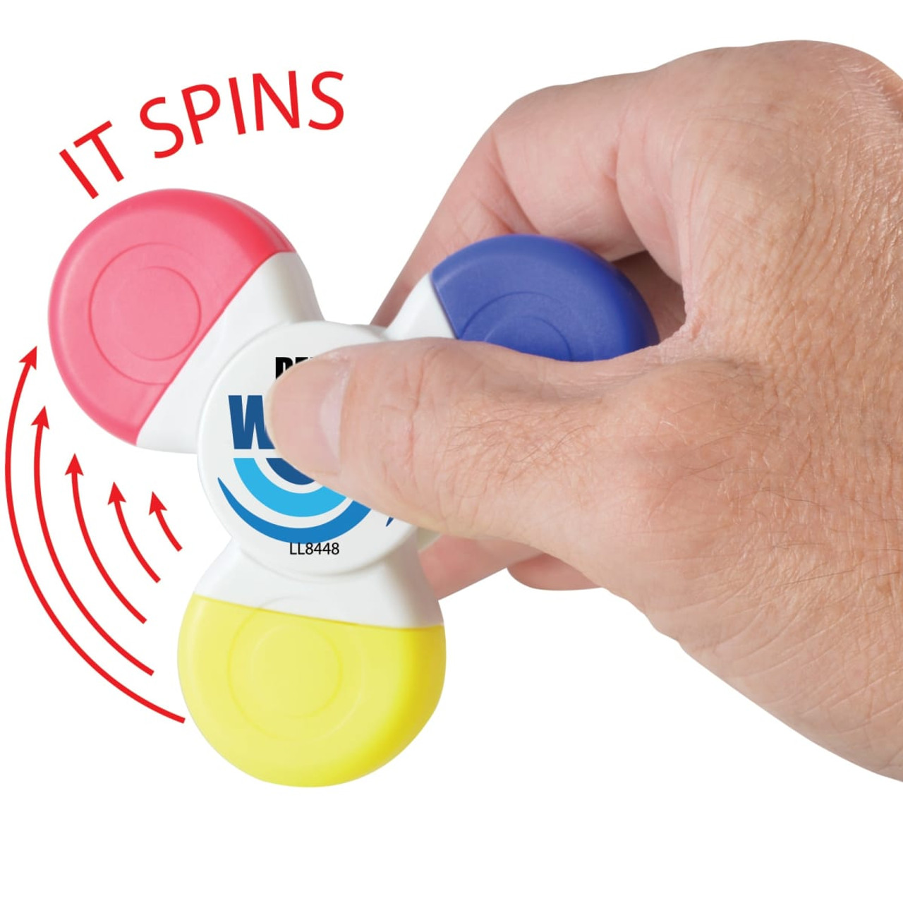 A Spinner Highlighter with red, blue, yellow, and pink sections, held in a hand, featuring the text "IT SPINS".