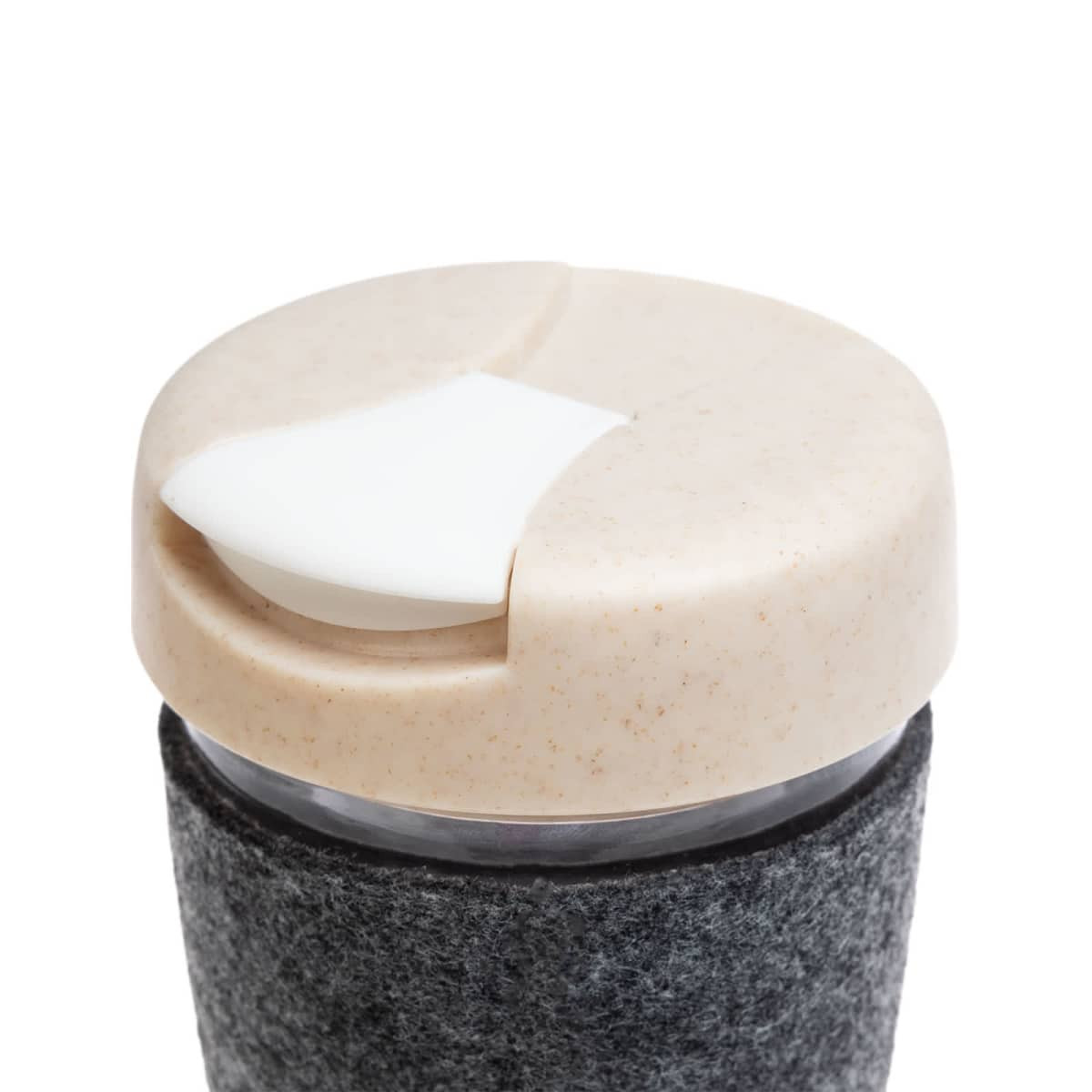 A reusable coffee cup with a textured band and a light-colored, lid featuring a sliding opening mechanism.