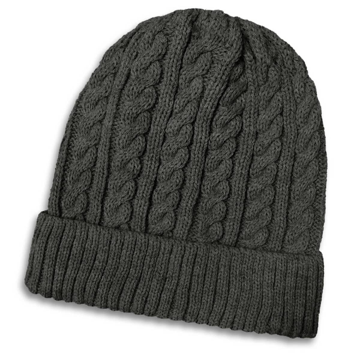 A dark grey knitted beanie featuring a cable knit design and a ribbed cuff. It includes a logo.