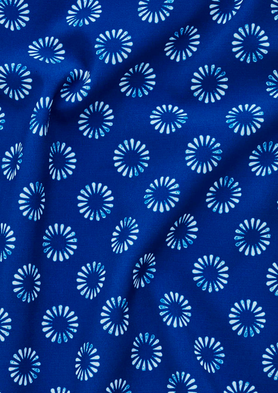 A blue tunic fabric featuring a white daisy print pattern. The material appears smooth and has a draping quality.